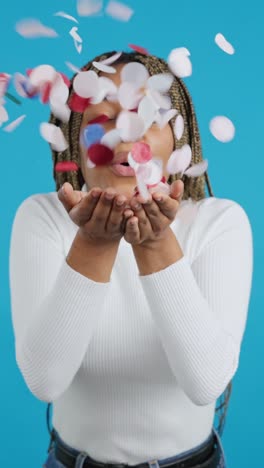 a woman blowing confetti in celebration