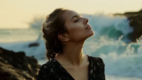 woman standing on a cliff overlooking a dramatic ocean sunset