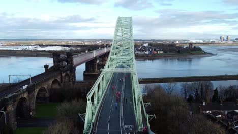 charity santa dash fun run over runcorn silver jubilee bridge aerial view slow push in shot