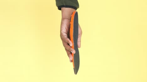 hand holding a pair of comfortable shoe insoles
