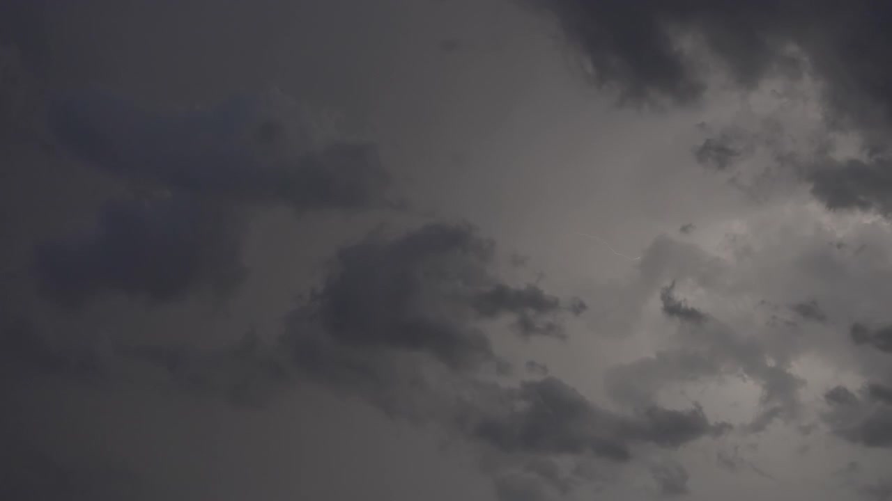 Fast lightning pulses inside dramatic storm clouds at night