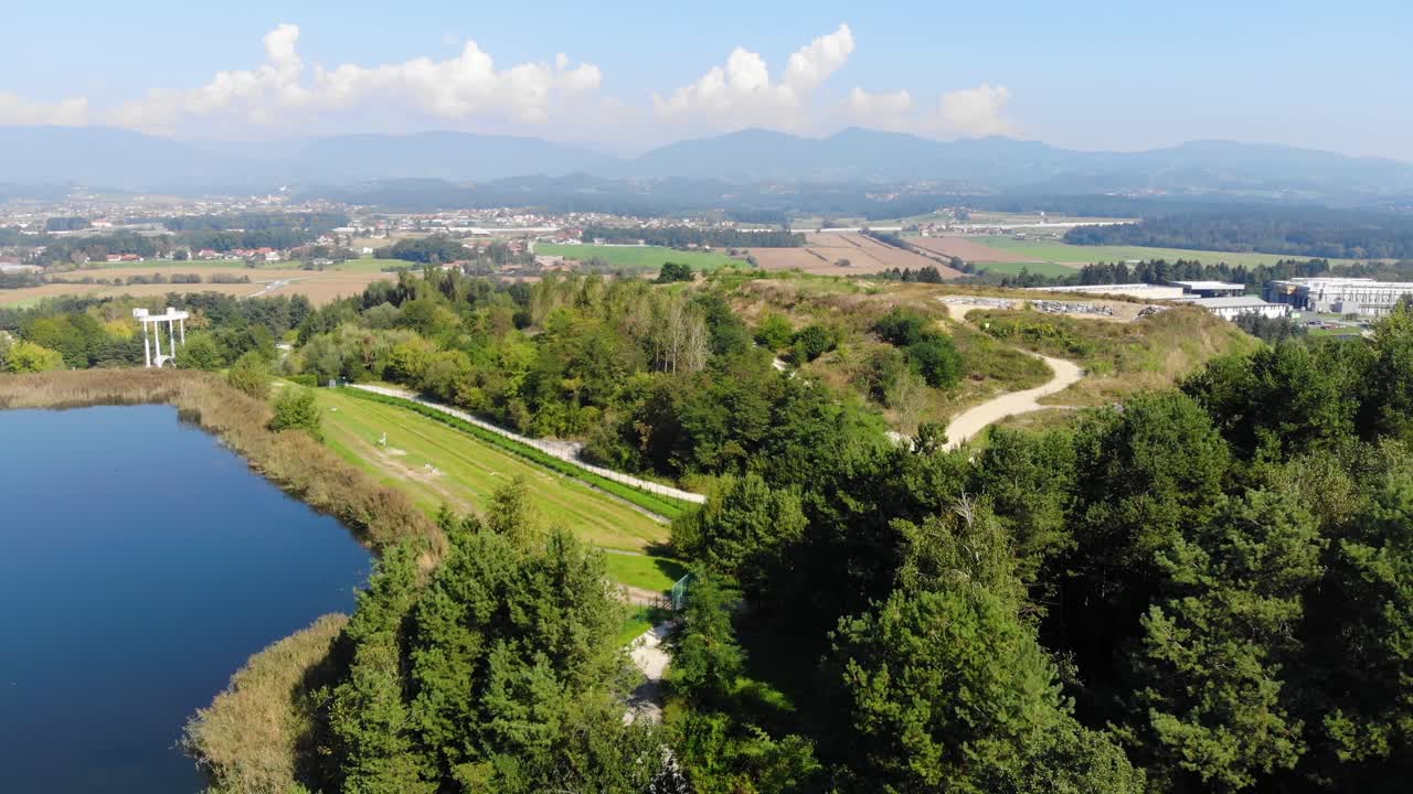 Landfill hill made of industrial waste near a plastic recycling plant in eastern Europe, Aerial flyover pan right view