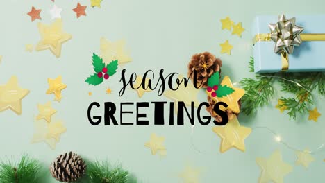 Animation-of-season-greetings-text-and-stars-over-presents-and-decorations