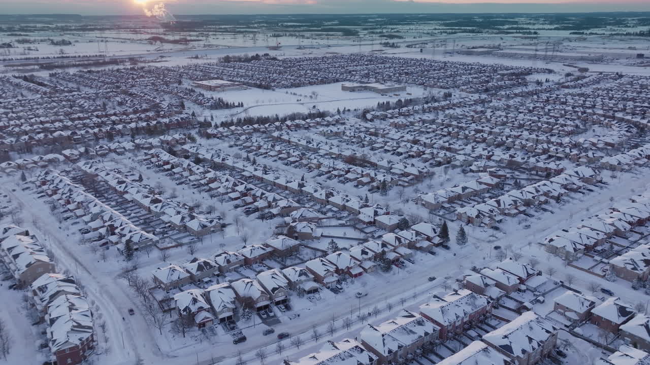 Snowy aerial view of Mississauga suburb at sunset in winter season