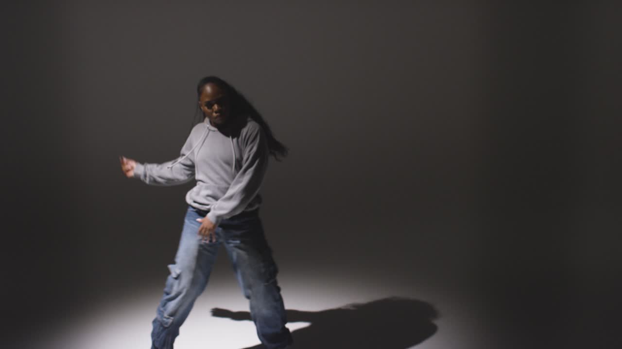 Full Length Studio Portrait Shot Of Young Woman Dancer Dancing In Spotlight With Shadows In Foreground 1