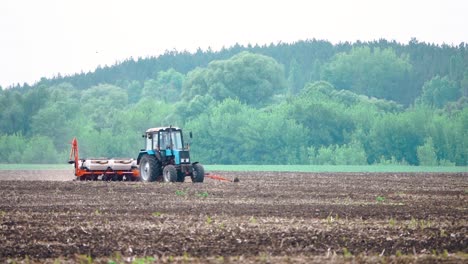 tractor planting seeds in a field