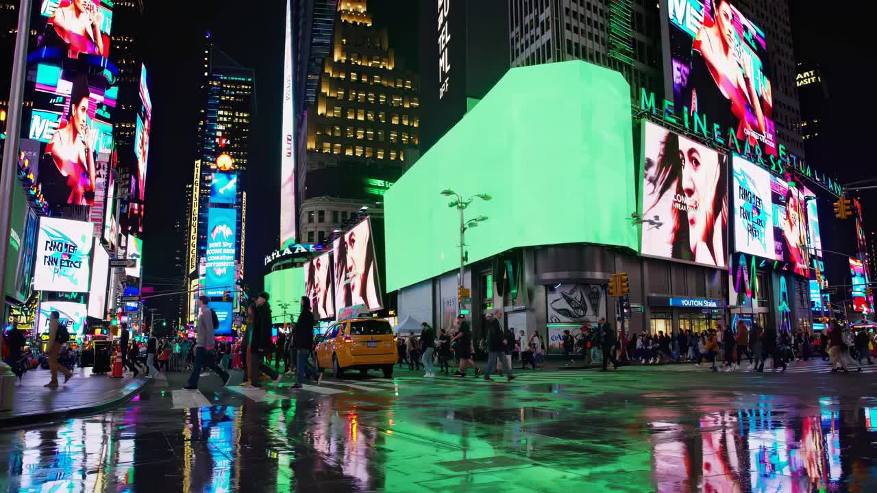 Vibrant cityscape video of Times Square at night, showcasing neon lights and bustling crowds