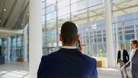 Caucasian-businessman-walking-in-the-lobby-at-office-4k