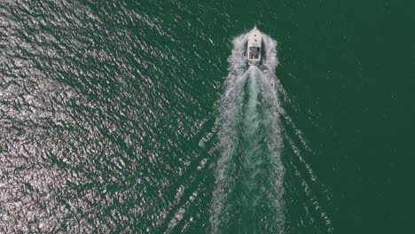 Aerial-View-Of-Speedboat-Leaving-Wake-In-The-Blue-Sea