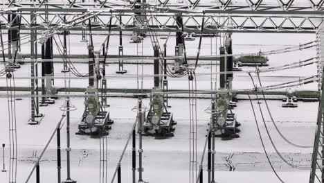 cable and power line close up in wintery transformation power station, drone truck shot