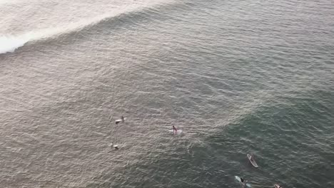 Drone-aerial-pan-down-Hawaii-surfers-sunset-waves