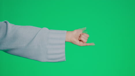 hand, shaka and a woman on a green screen