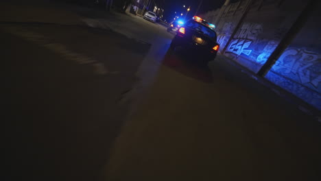 fpv chasing shot of police cars with flashing lights responding to an incident