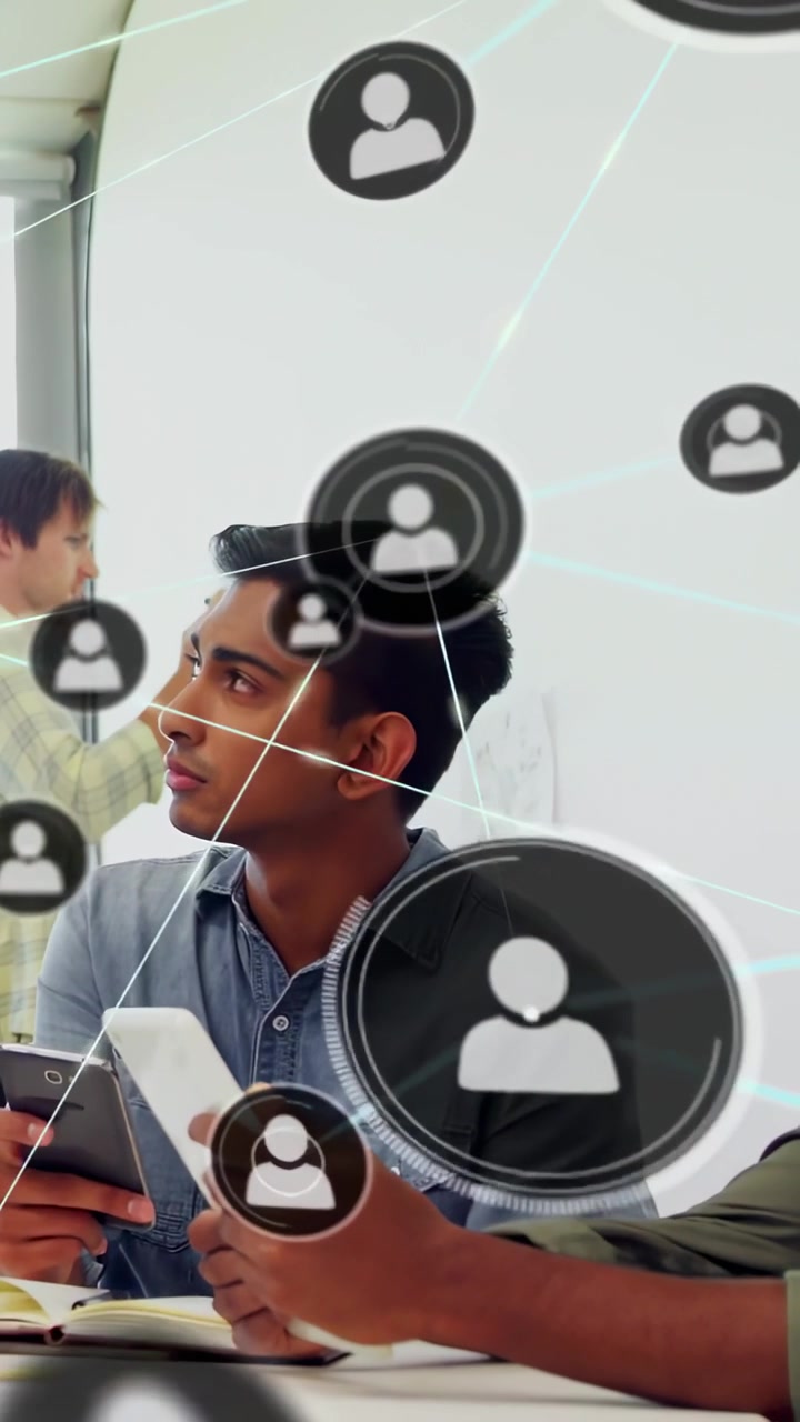 Vertical video: Seated man with phone watching host gesturing moving icons linking into biz network