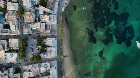 Aerial-footage-of-the-town-and-port-of-Parikia-on-the-island-of-Paros,-one-of-the-many-Cyclades-Islands-in-the-Aegean-Sea