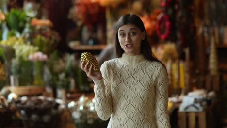 woman looking at christmas ornament