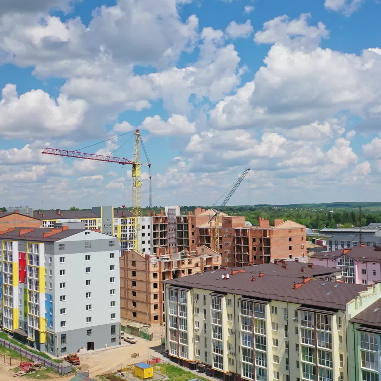 Constructions site with heavy machinery. Aerial flight over new constructions development site