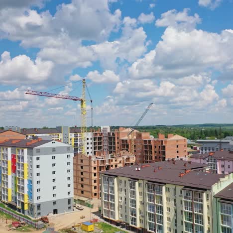 constructions site with heavy machinery. aerial flight over new constructions development site