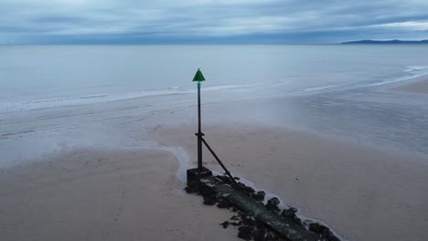 coastal tide marker aerial view rising above scenic low tide seaside beach