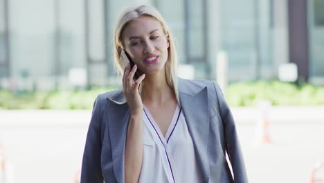 businesswoman speaking on phone on street