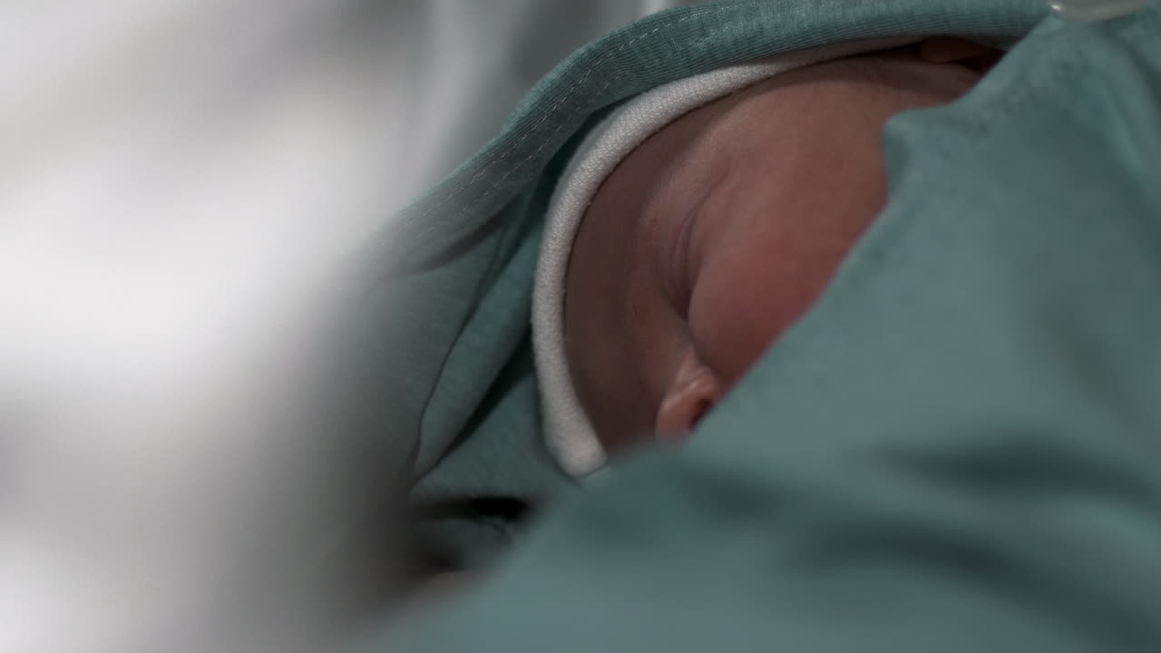 Newborn baby sleeping and resting in hospital room, motion view