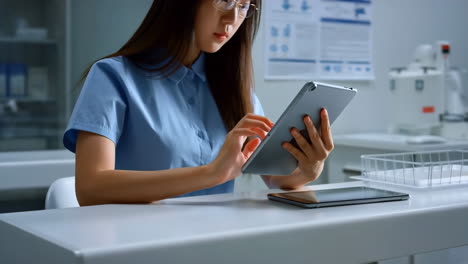 scientist or professional using tablet in a lab/office