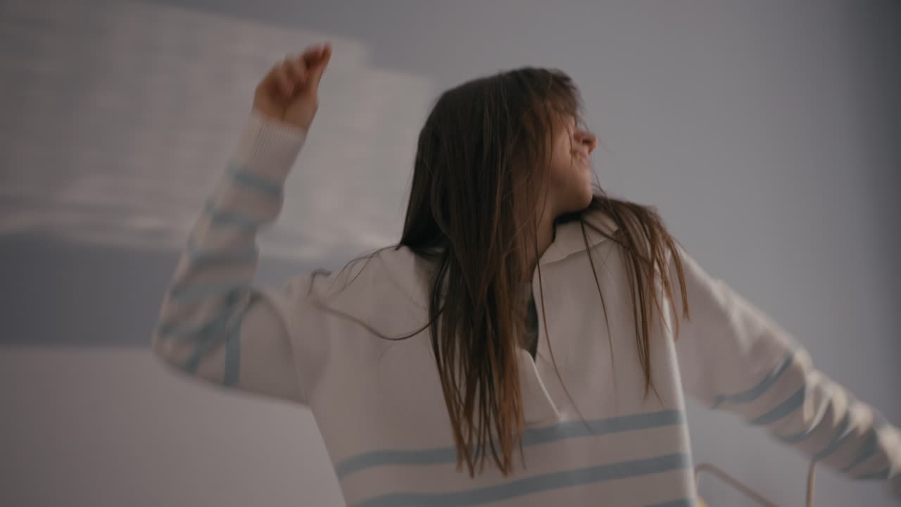 Woman dancing in her bedroom