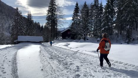 people walking in justistal in winter full of snow in the bernese oberland in switzerland