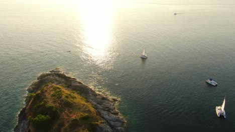 vista superior de drones botes panorámicos en la orilla del mar durante la puesta de sol de laem phromthep cape en la provincia de phuket, tailandia.