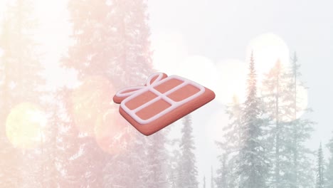 animation of christmas gift gingerbread cookie over snow falling in winter scenery