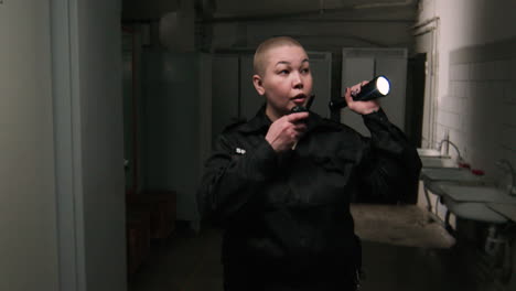 female safety guard with flashlight in a warehouse