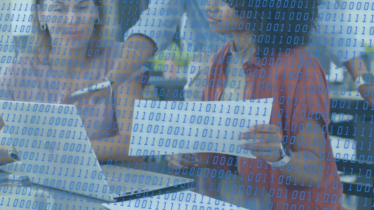 Woman in red holding binary sheet, two at laptop leaning, pointing, analyzing with binary overlay