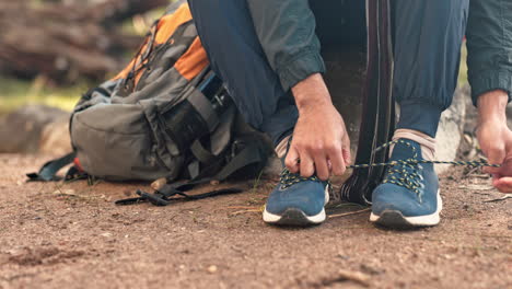 hiking, nature and hands tie shoes outdoors