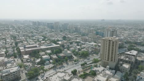 aerial drone shot of heavy traffic movement over shahrah e qaideen road, karachi metropolitan city, pakistan on a sunny day