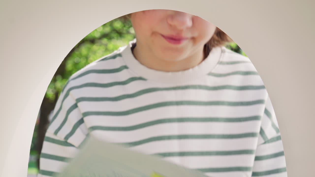 Young Child Taking Out Letters from Outdoor Mailbox in Park