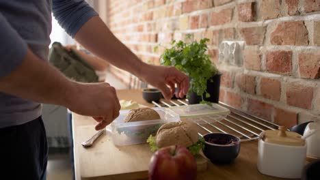 video of father and son packing healthy food for school