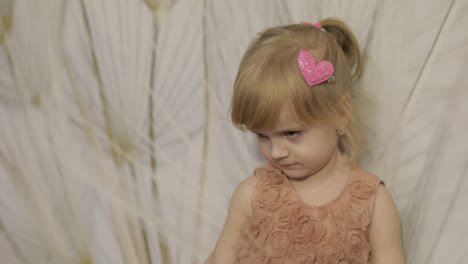 Happy-three-years-old-girl-make-faces-and-dancing.-Cute-blonde-child