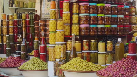 variety of preserved olives displayed at olive shop in souk. marrakesh, morocco. static shot