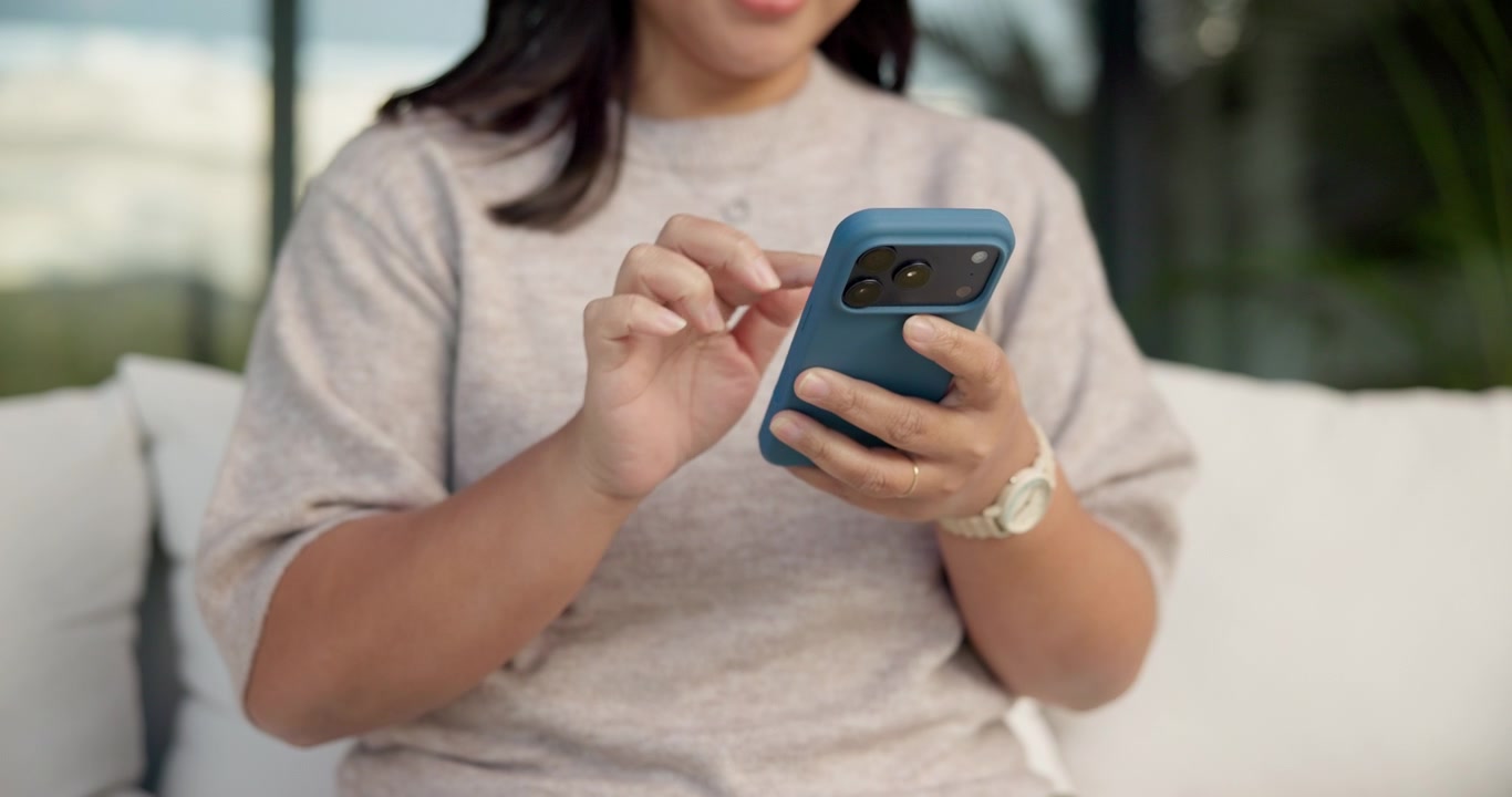 Woman Using Smartphone While Sitting on Sofa