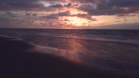 Incredible-drone-shot-of-beach-and-waves-in-sunset,-Brazil,-Atlantic-ocean