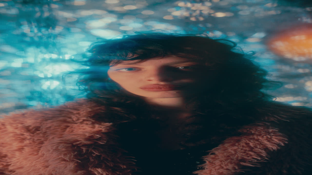 Portrait of Fashion Model in Fur Jacket Surrounded by Flickering Lights