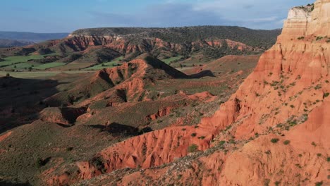 Aerial-view-of-a-colorful-red-dessert-canyon-at-dawn-in-Treuel,-Spain