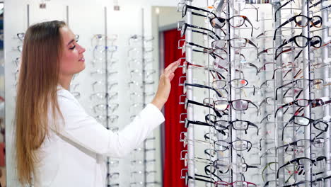 woman trying new eyeglasses. woman choosing her new glasses at optics store