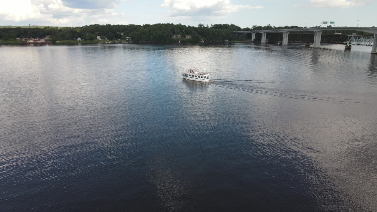 Small cruise tour boat on the Kennebec river, aerial drone shot