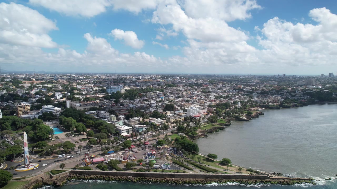 Vista panoramica aerea con drone della costa di Santo Domingo, che cattura la foce del fiume Ozama, il Mar dei Caraibi, lo skyline della città, l'infrastruttura urbana e il quartiere coloniale di giorno