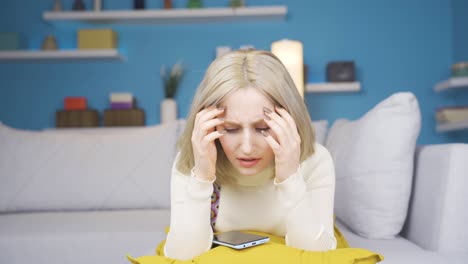 Young-woman-getting-angry-at-phone-message-and-throwing-phone.-He-is-upset.