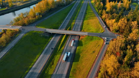 transport moves by the highways outside the big cities. aerial perspective on the roads built along the narrow river in oregon state, usa.