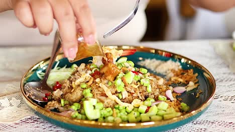 adding ingredients to shrimp paste fried rice