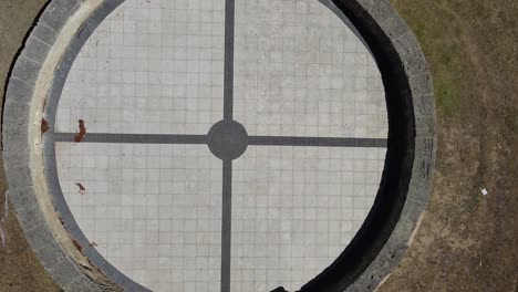 aerial lift up view over circular paved lookout area of a park