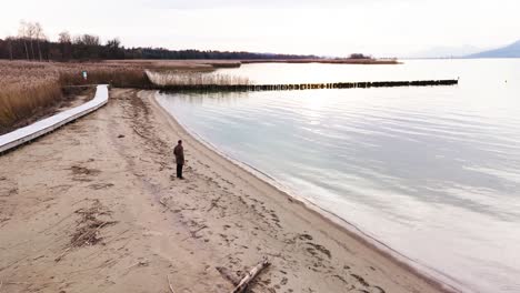 a man stands alone on the beach